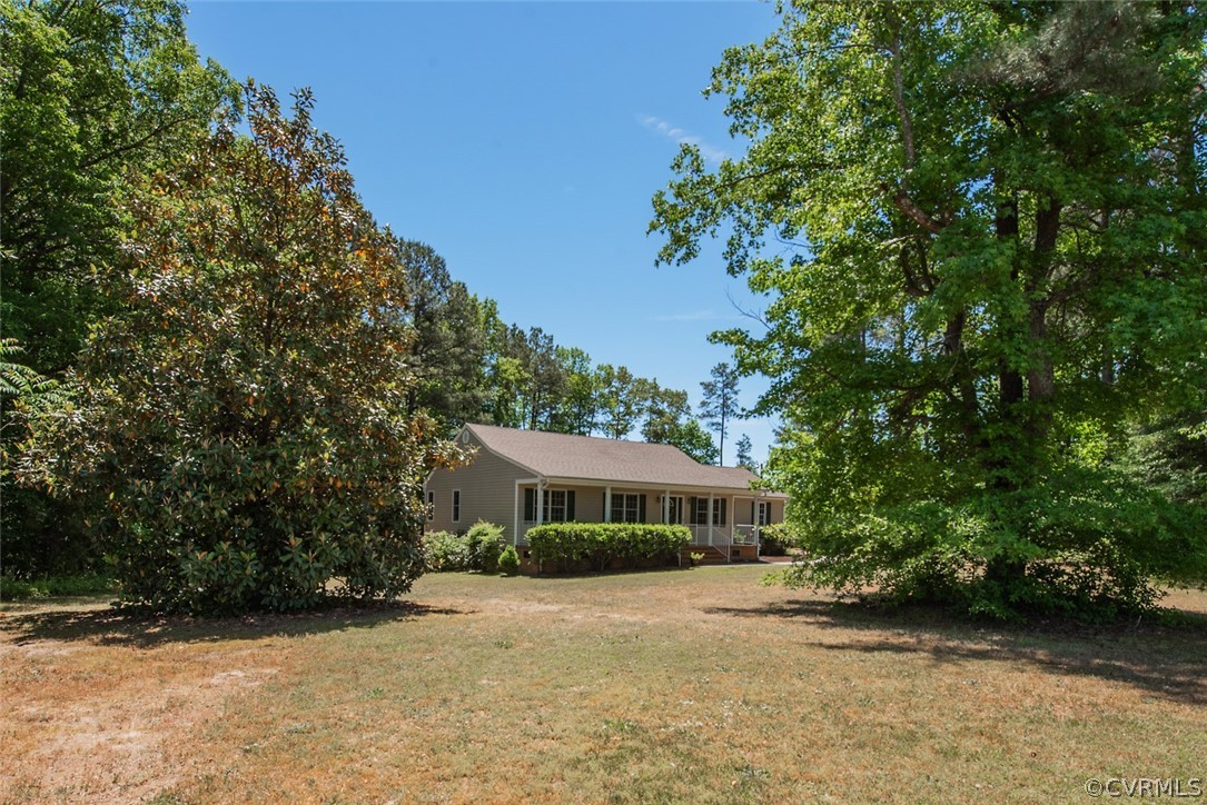 21417 Courthouse Road Dinwiddie, VA 23841 - Photo 44 of 50 a front view of a house with a garden