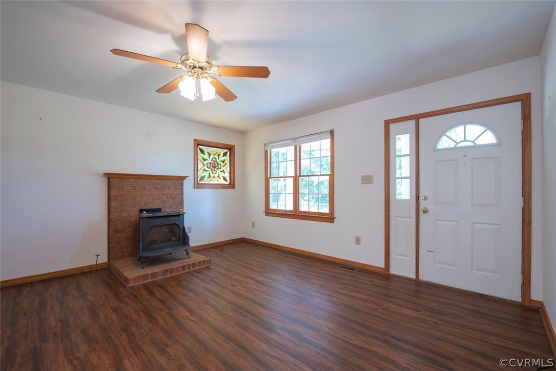 21417 Courthouse Road Dinwiddie, VA 23841 - Photo 5 of 50 an empty room with wooden floor fan and windows