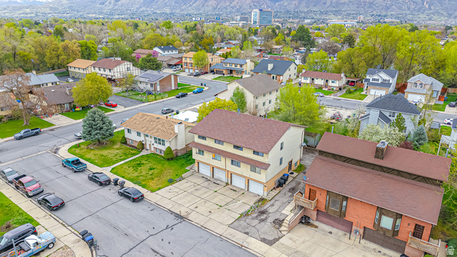 630 1100 West Provo, UT 84601 - Photo 61 of 64 Multi-unit property with a brick and stucco exterior, featuring multiple garage bays and a brown shingle roof
