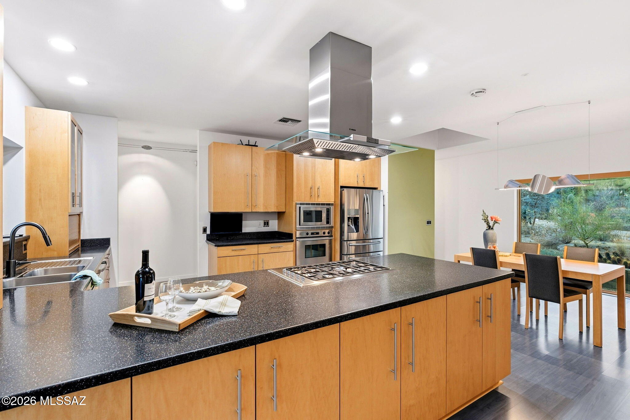5070 North Valley View Road Tucson, AZ 85718 - Photo 16 of 51 a kitchen with stainless steel appliances granite countertop a sink counter space and living room view