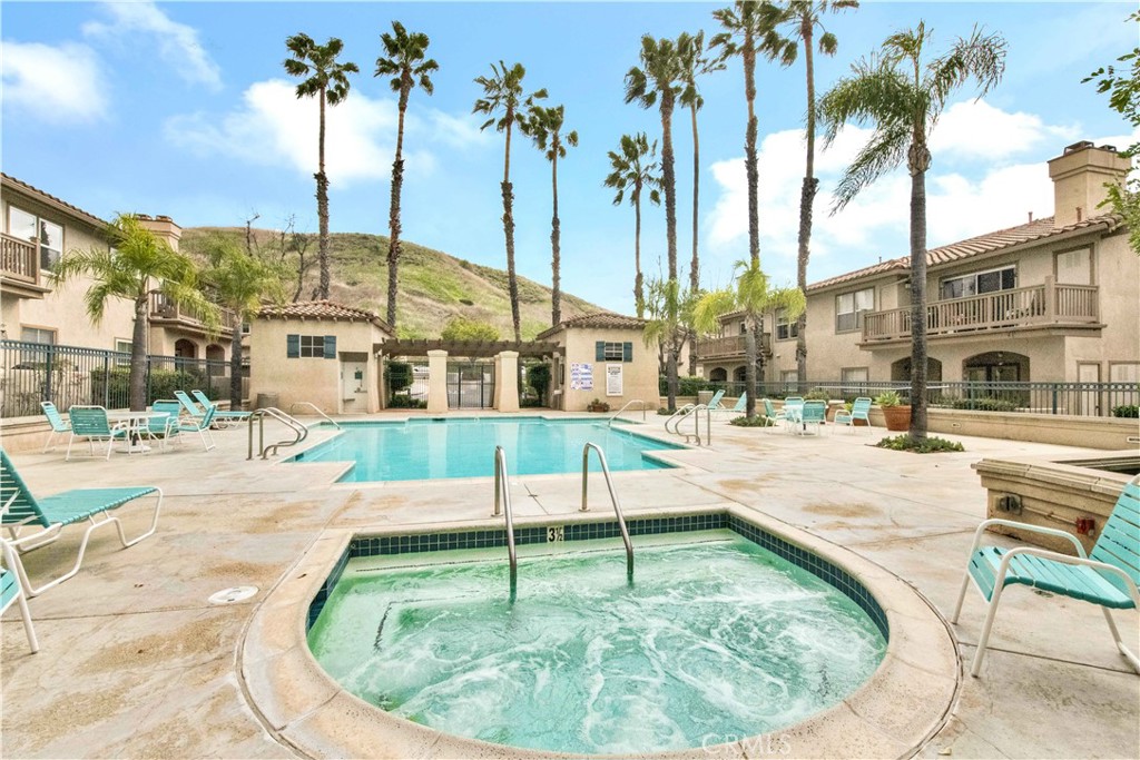 68 Abrigo Rancho Santa Margarita, CA 92688 - Photo 2 of 70 a view of a swimming pool with a view of palm trees