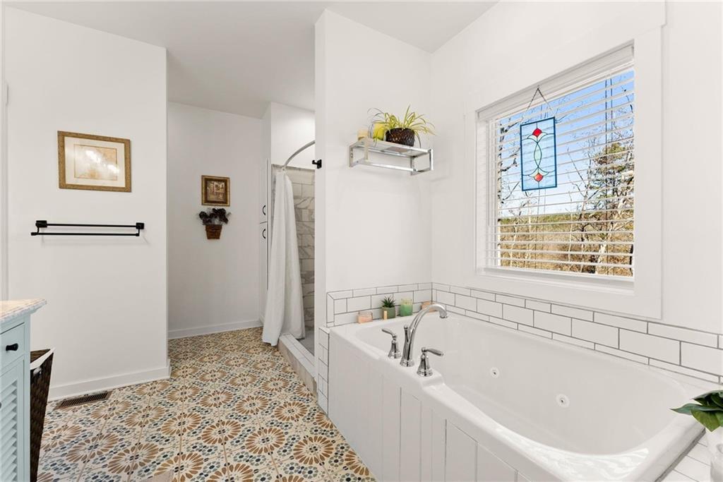 434 Riverbend Lane Bogart, GA 30622 - Photo 22 of 62 a bathroom with a bathtub and a shower