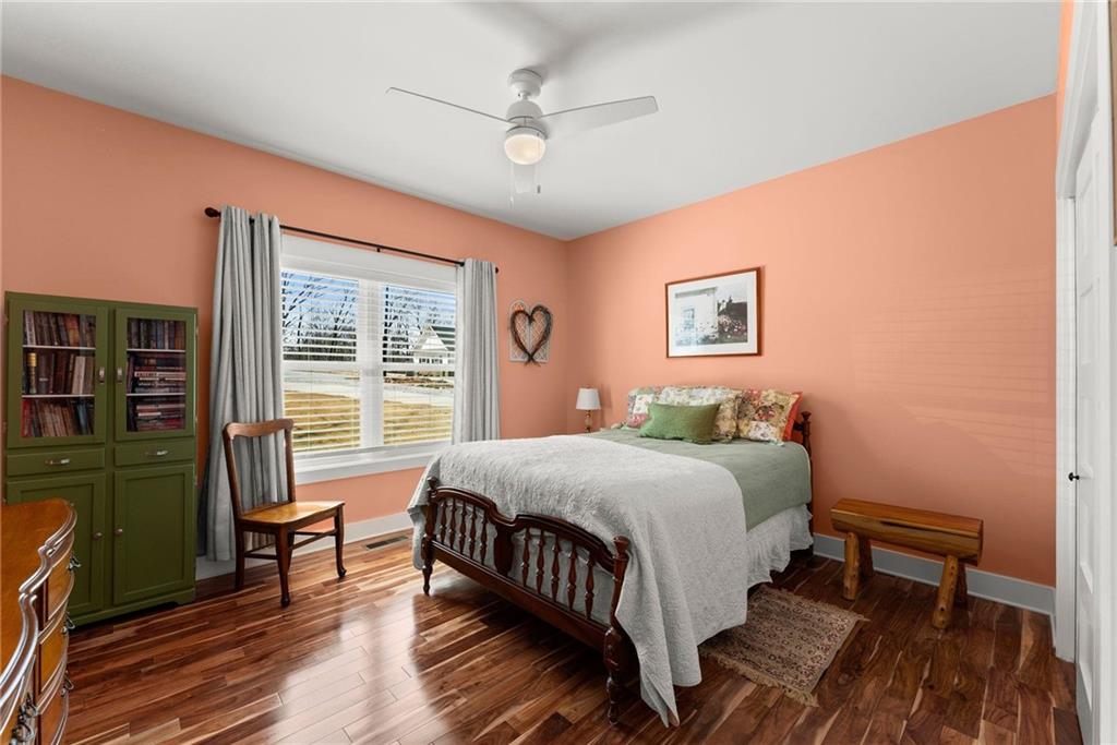 434 Riverbend Lane Bogart, GA 30622 - Photo 25 of 62 a bedroom with a bed wooden floor and window