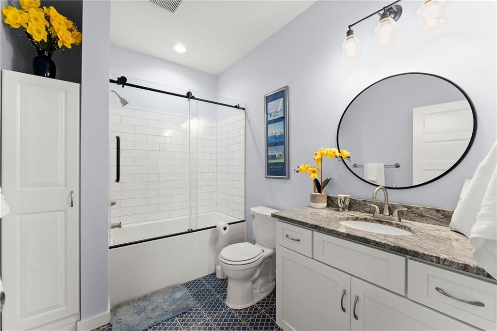 434 Riverbend Lane Bogart, GA 30622 - Photo 27 of 62 a bathroom with a granite countertop toilet sink and mirror