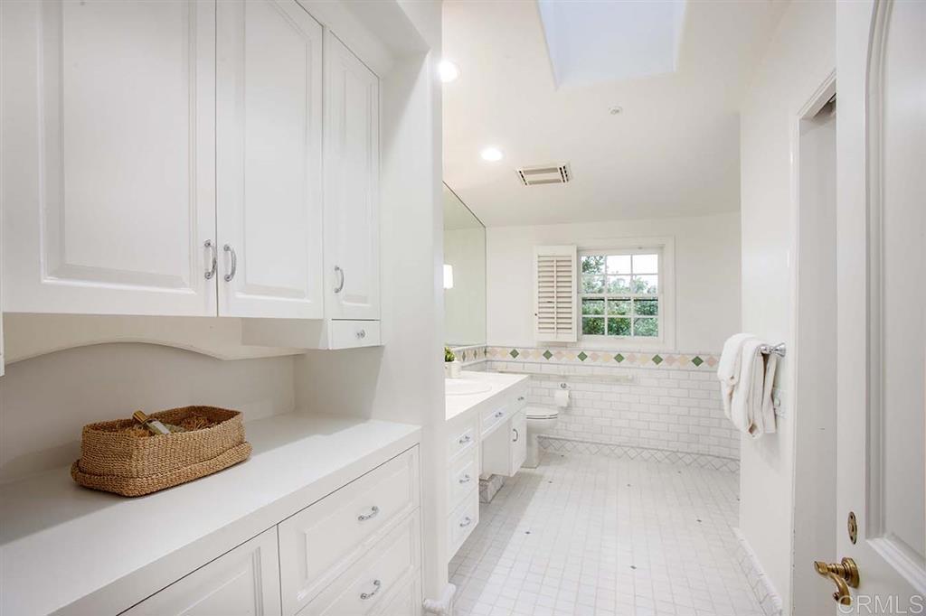 6019 La Flecha Rancho Santa Fe, CA 92067 - Photo 18 of 25 a kitchen with white cabinets and window