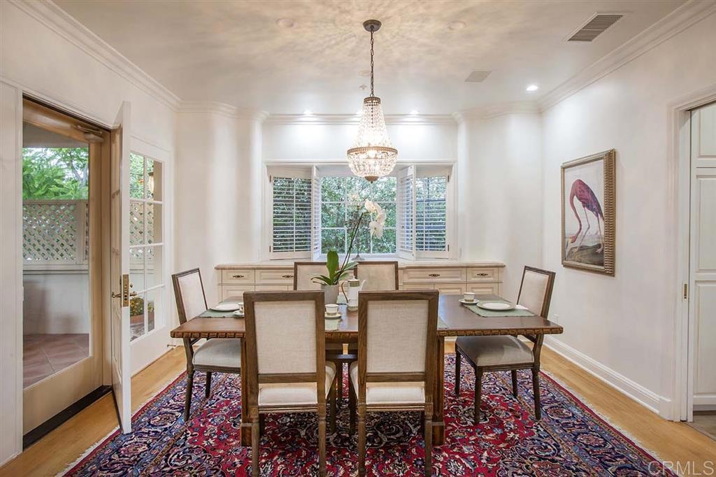6019 La Flecha Rancho Santa Fe, CA 92067 - Photo 7 of 25 a dining room with furniture a chandelier and wooden floor