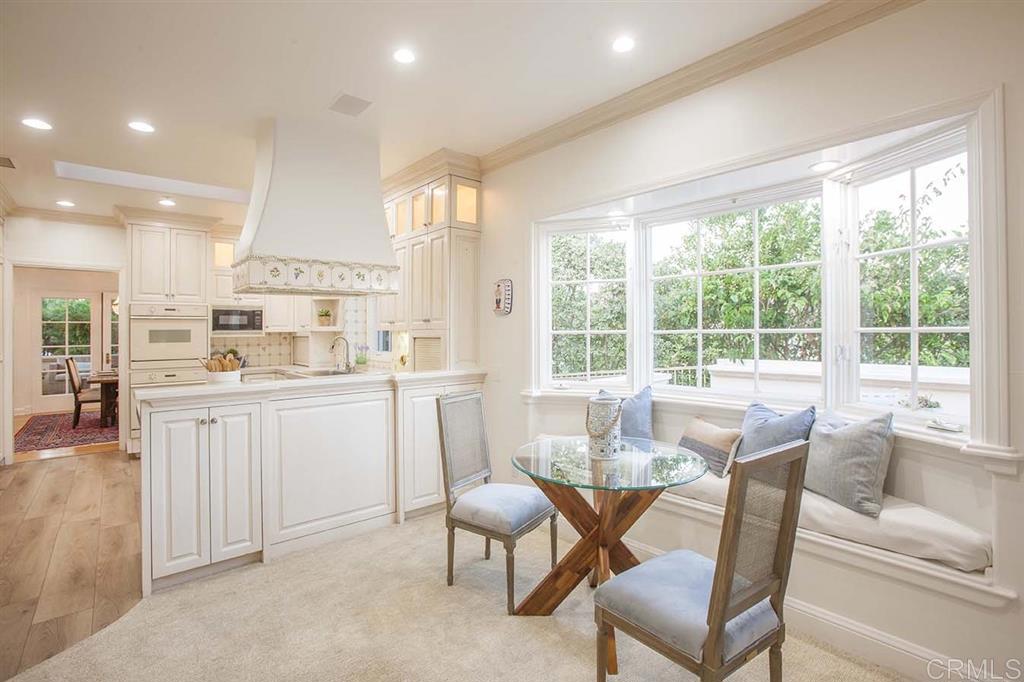 6019 La Flecha Rancho Santa Fe, CA 92067 - Photo 9 of 25 a dining room with furniture a rug and a kitchen view