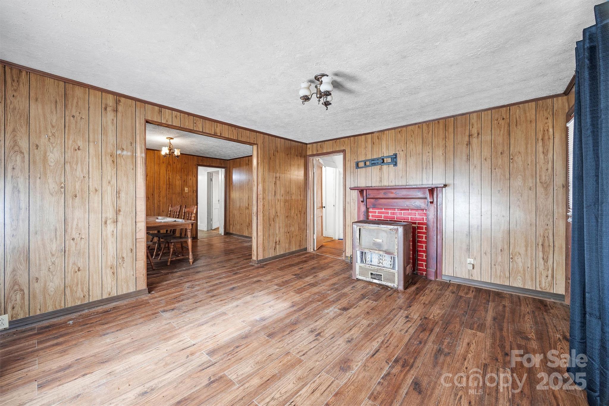 2012 State Road 30 Chester, SC 29706 - Photo 5 of 35 an empty room with wooden floor fireplace and windows