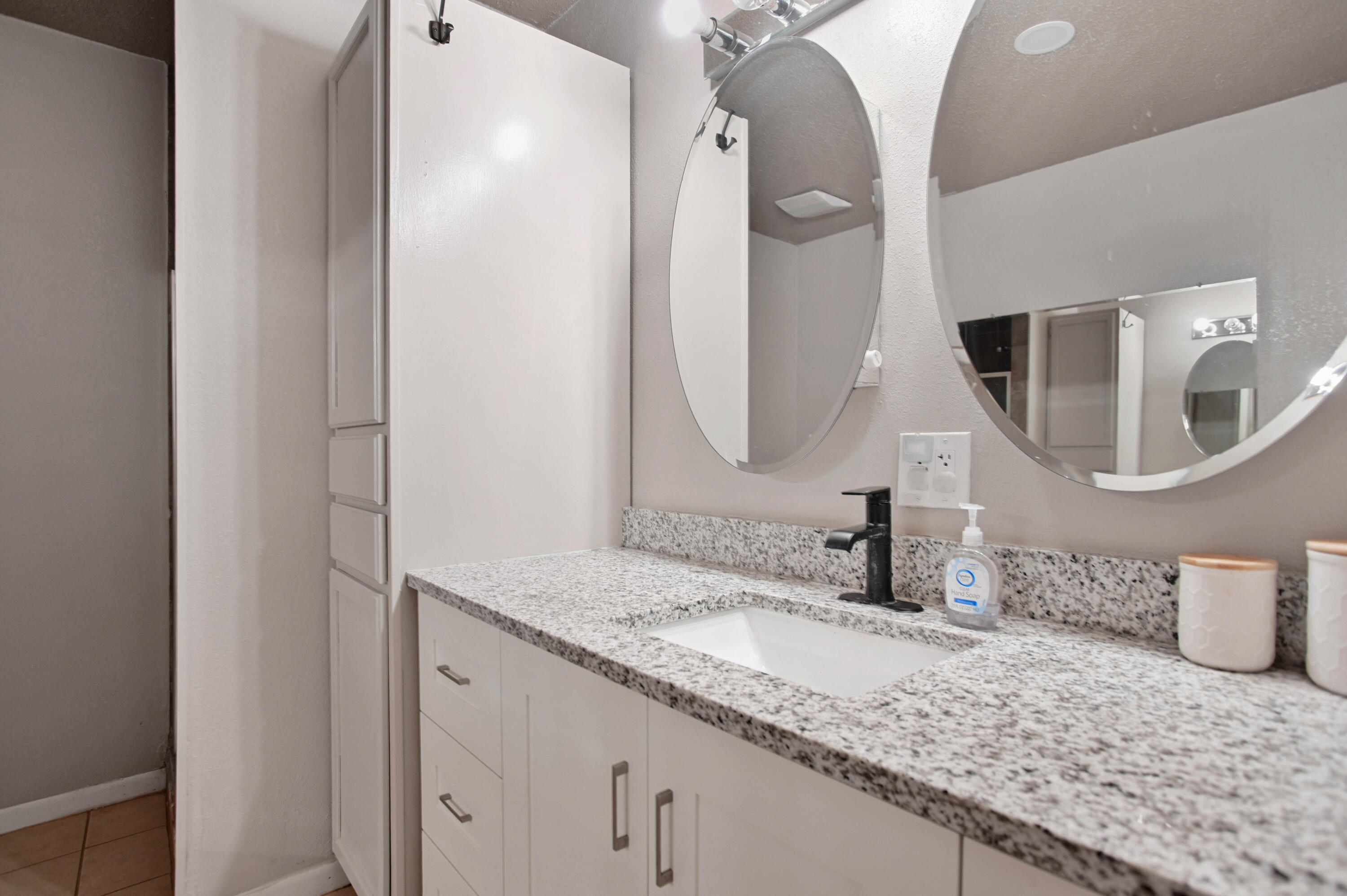704 4th Street Smyer, TX 79367 - Photo 30 of 38 a bathroom with a granite countertop sink and a mirror