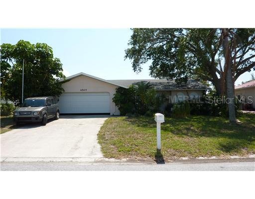 4507 Mangrove Point Road Bradenton, FL 34210 - Photo 1 of 1 a swimming pool view with a garden