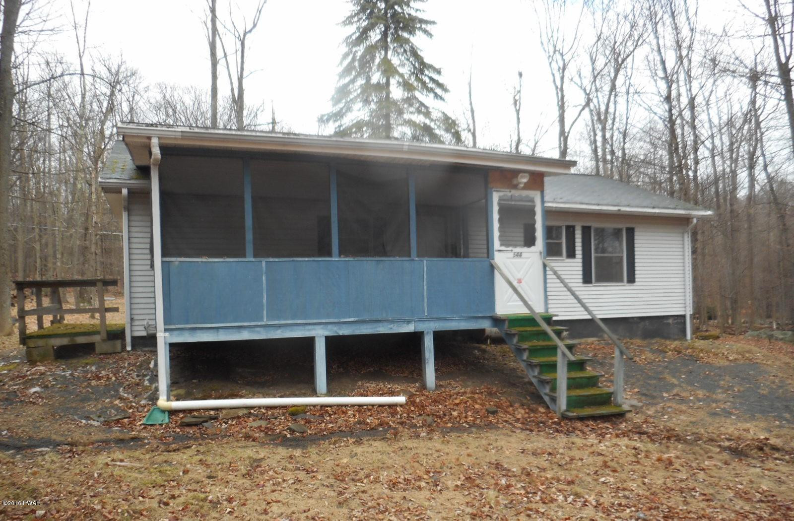 544 Hummingbird Lane Hawley, PA 18428 - Photo 4 of 16 a backyard of a house with table and chairs
