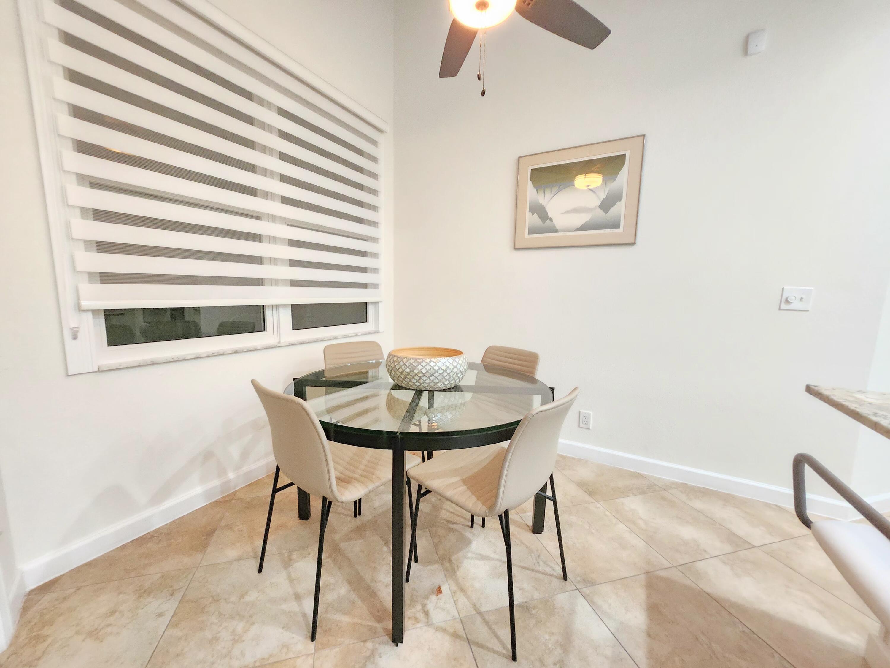 3567 Commodore Circle Delray Beach, FL 33483 - Photo 20 of 76 a view of a dining room with furniture and a large window