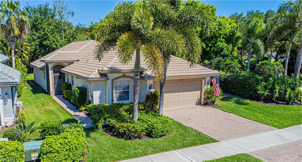 a aerial view of a house with a yard and potted plants
