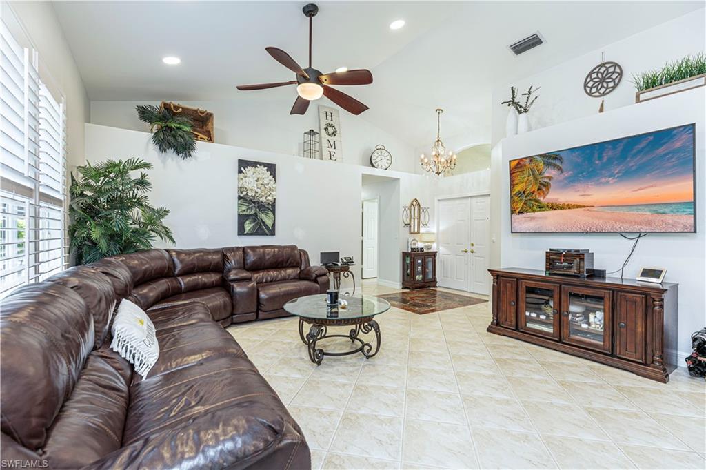 1364 Triandra Lane Naples, FL 34119 - Photo 3 of 27 a living room with furniture and a flat screen tv