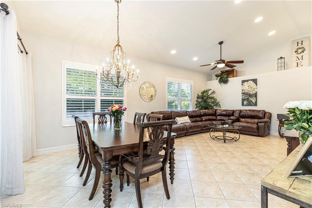 1364 Triandra Lane Naples, FL 34119 - Photo 4 of 27 a view of a dining room with furniture and chandelier
