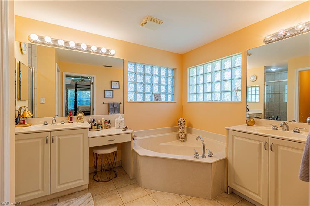 1364 Triandra Lane Naples, FL 34119 - Photo 7 of 27 a bathroom with a tub sink and mirror
