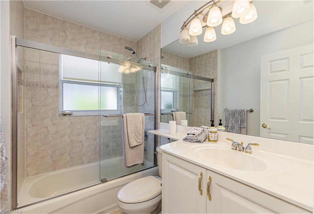 1364 Triandra Lane Naples, FL 34119 - Photo 9 of 27 a bathroom with a sink a toilet and shower