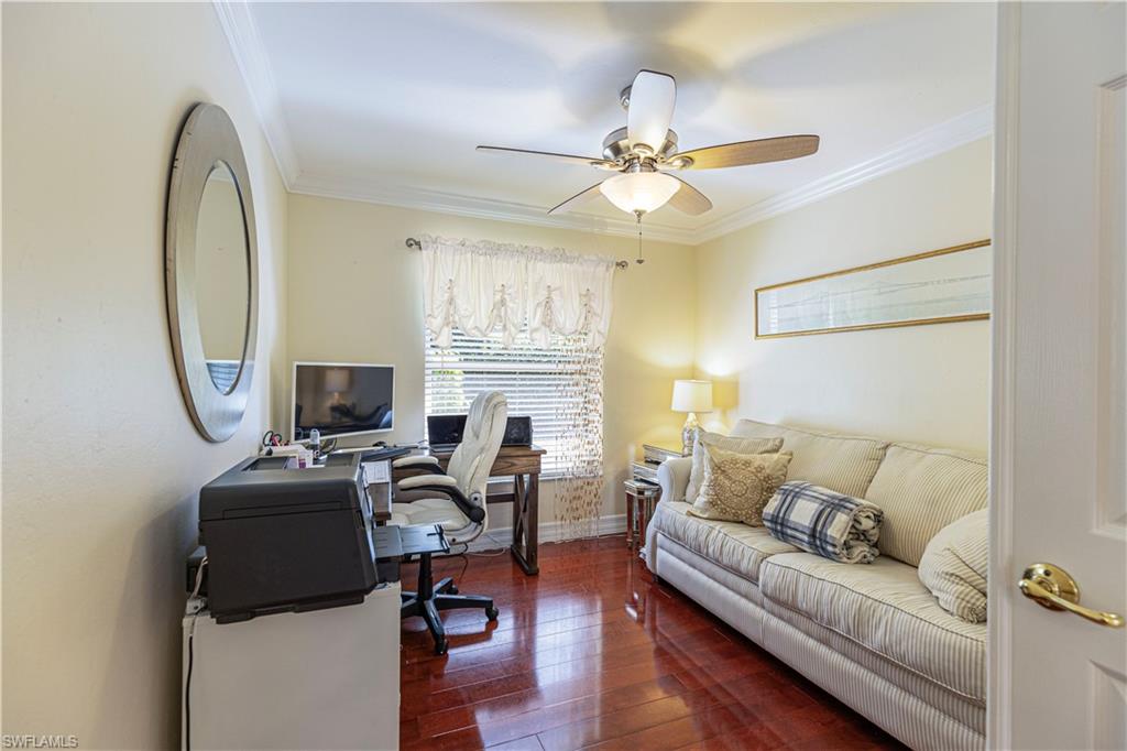 1364 Triandra Lane Naples, FL 34119 - Photo 10 of 27 a living room with furniture a fireplace and a flat screen tv