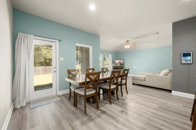 a dining room with furniture and wooden floor