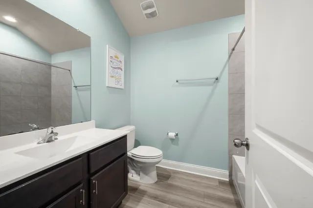 a bathroom with a sink a toilet a shower and a mirror