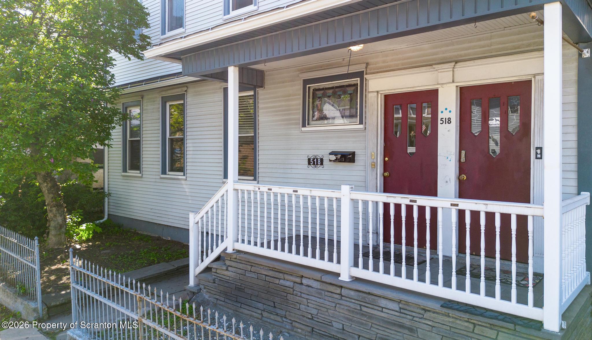 518 Prospect Avenue Scranton, PA 18505 - Photo 6 of 59 a porch with a bench next to a yard