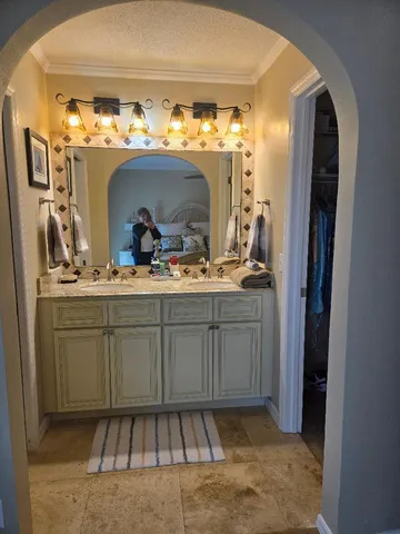 a bathroom with mirror and sink