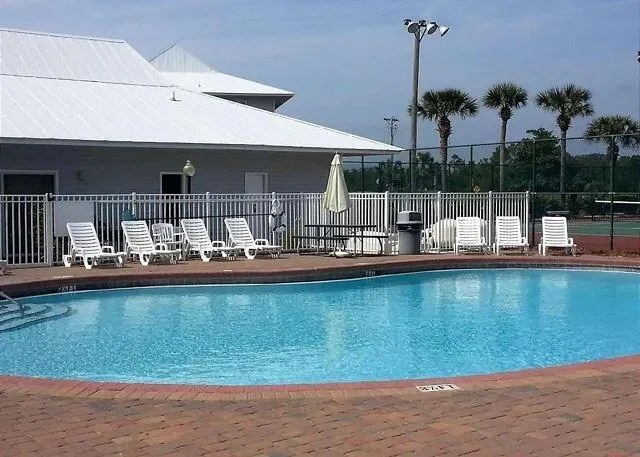a view of a swimming pool with outdoor seating