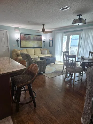 a view of a dining room with furniture and wooden floor