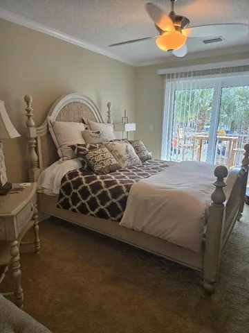 a bedroom with a bed chair and window