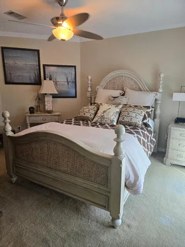 a bedroom with a bed and a painting on the wall