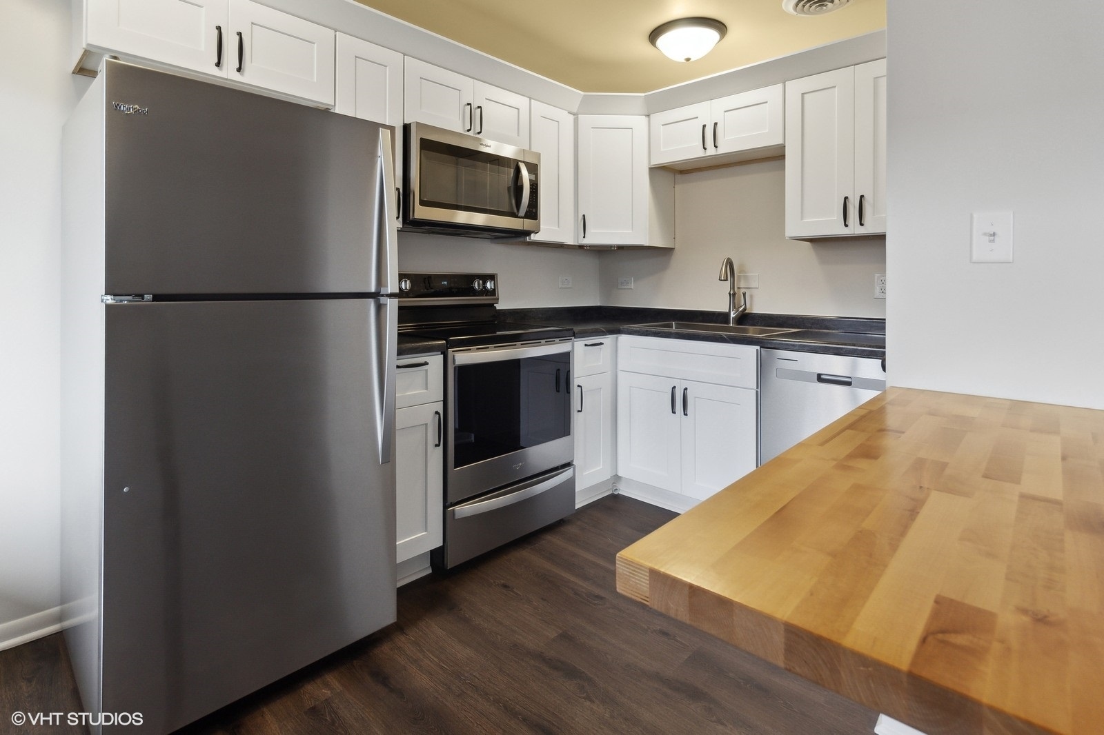 755 South Nelson Avenue, Unit 7 Kankakee, IL 60901 - Photo 2 of 9 a kitchen with a refrigerator stove and microwave