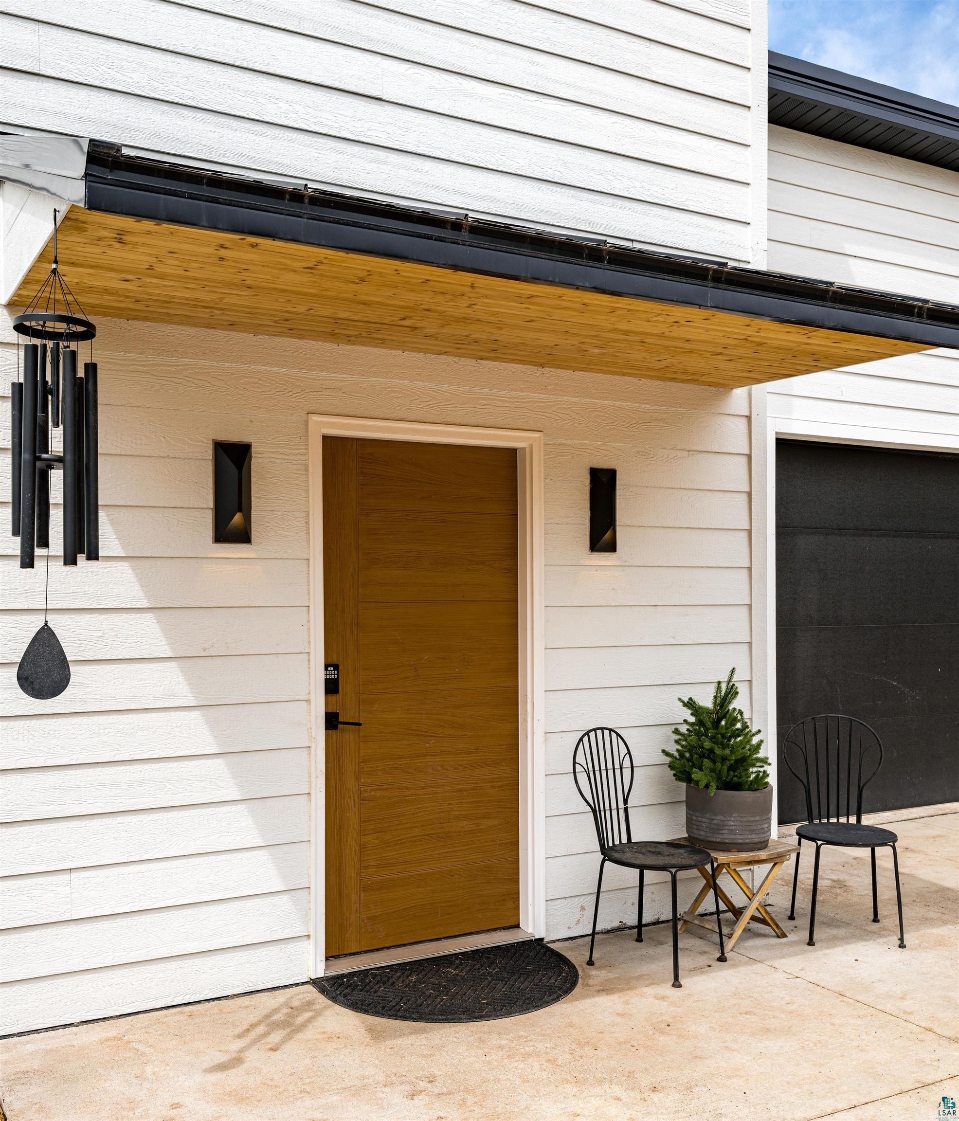 1825 East Shilhon Road Duluth, MN 55804 - Photo 7 of 37 Entryway featuring a composite-finish door, white LP horizontal siding and overhang entry w/metal roof.