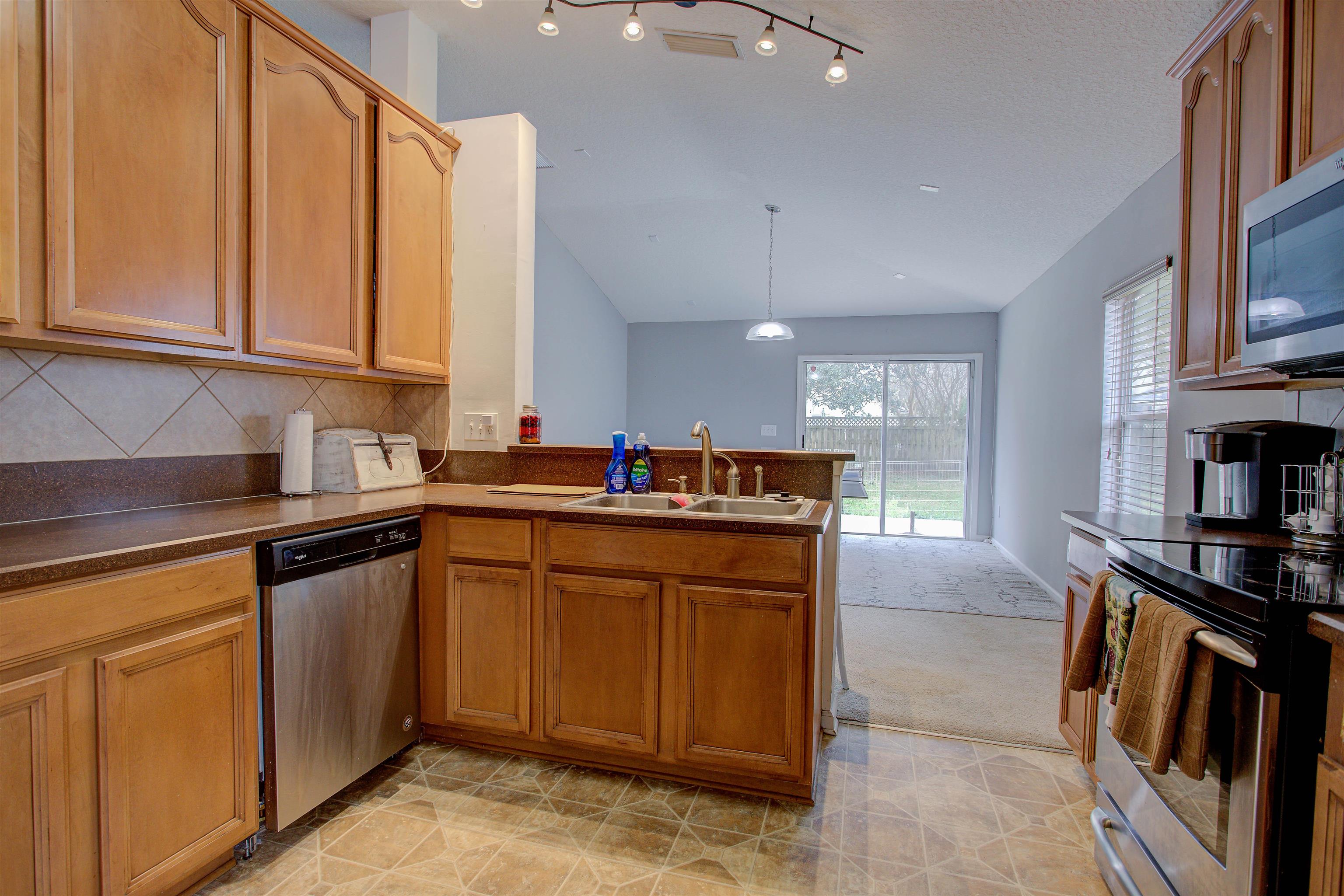 939 Silver Spring Court St. Augustine, FL 32092 - Photo 31 of 79 a kitchen with stainless steel appliances granite countertop a stove a sink and a microwave