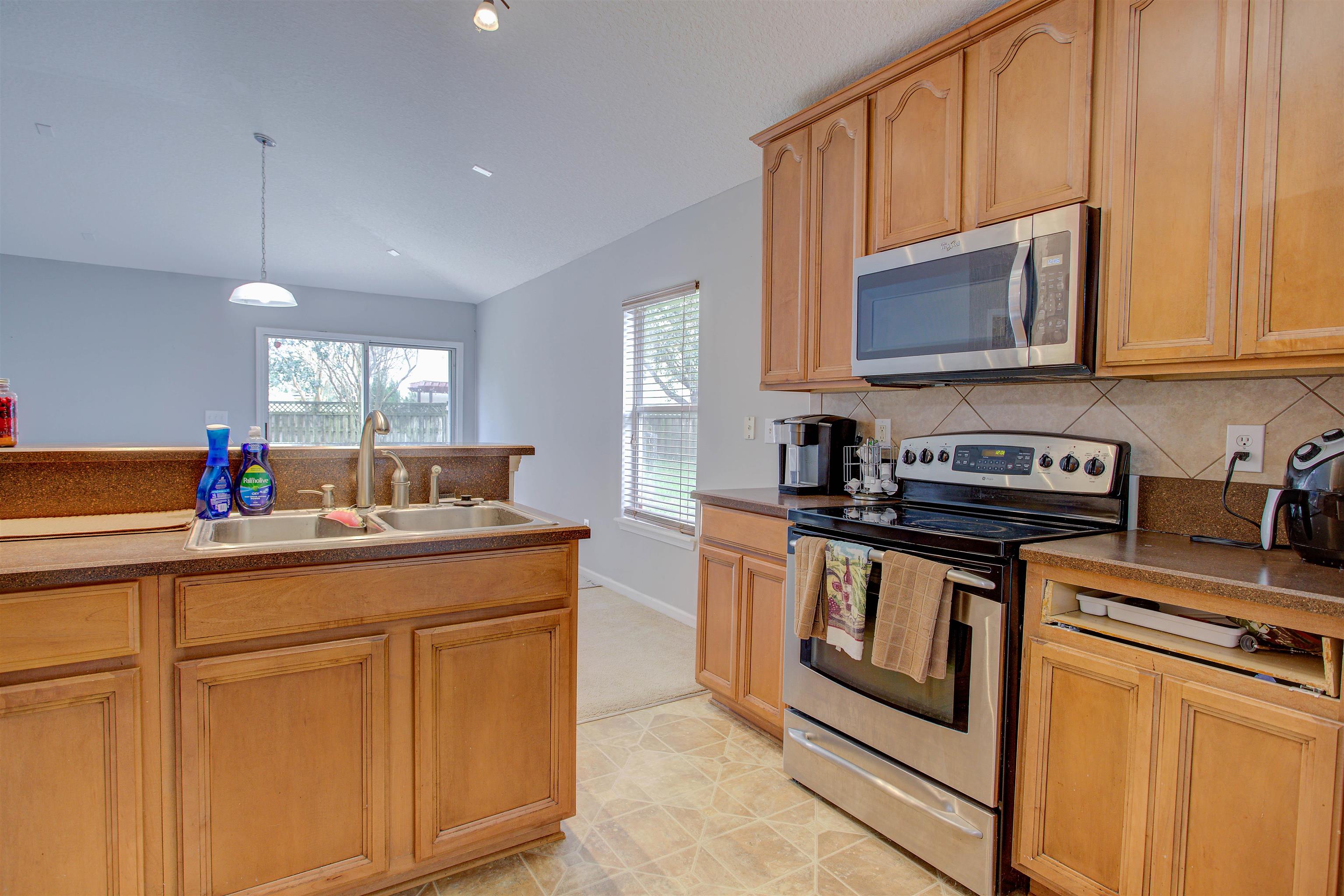 939 Silver Spring Court St. Augustine, FL 32092 - Photo 32 of 79 a kitchen with stainless steel appliances granite countertop a sink and a stove