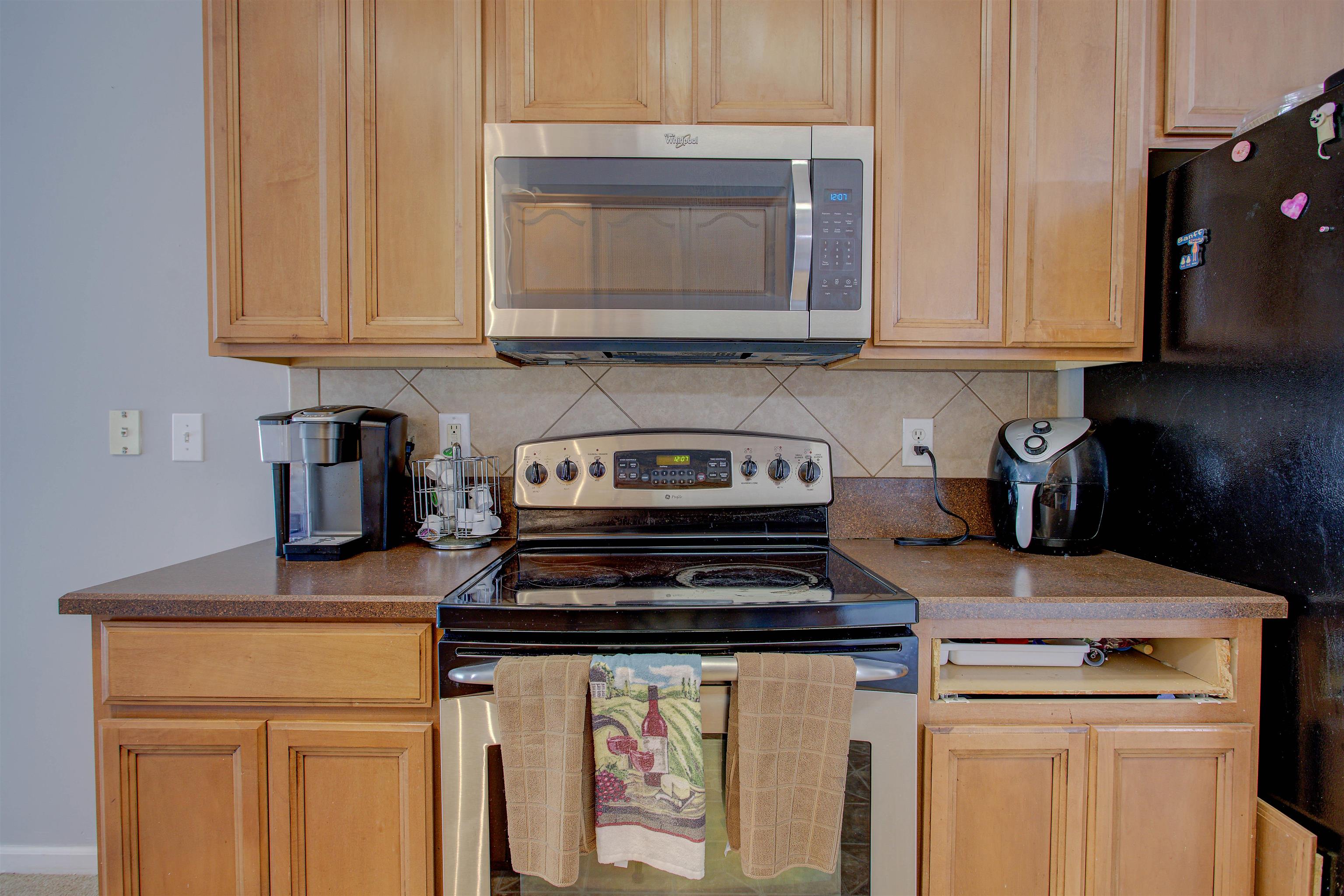 939 Silver Spring Court St. Augustine, FL 32092 - Photo 34 of 79 a kitchen with stainless steel appliances granite countertop a stove and a white cabinets
