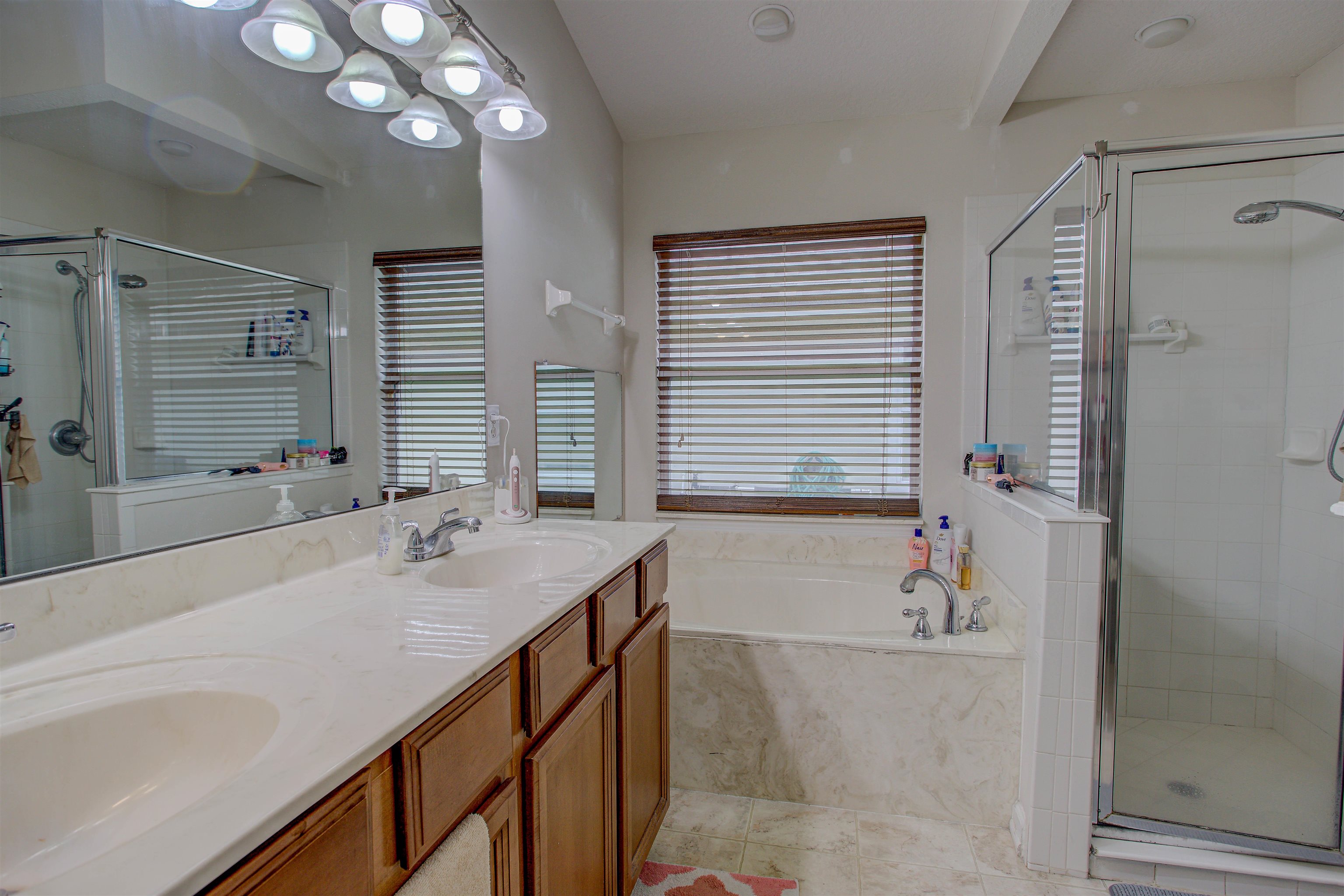 939 Silver Spring Court St. Augustine, FL 32092 - Photo 51 of 79 a bathroom with a tub sink and mirror
