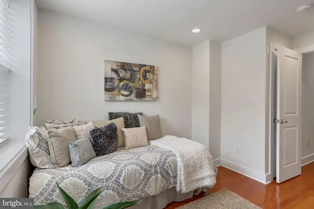 a bedroom with a bed and a painting on the wall