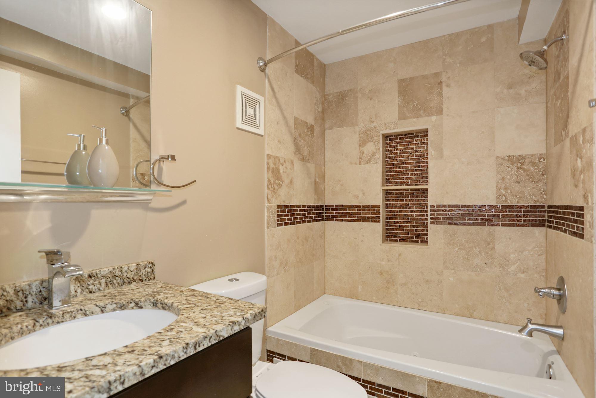 43 Hanover Place Northwest, Unit 1 Washington, DC 20001 - Photo 12 of 23 a bathroom with a granite countertop sink and a mirror