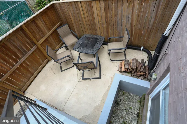a view of balcony with wooden floor and outdoor seating