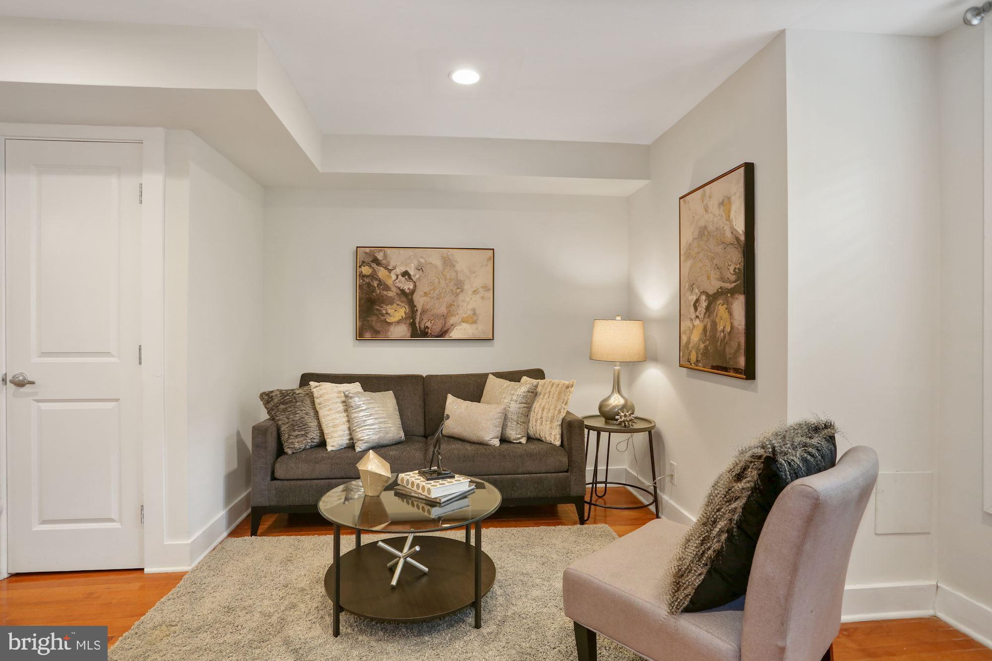 43 Hanover Place Northwest, Unit 1 Washington, DC 20001 - Photo 9 of 23 a living room with furniture and a lamp