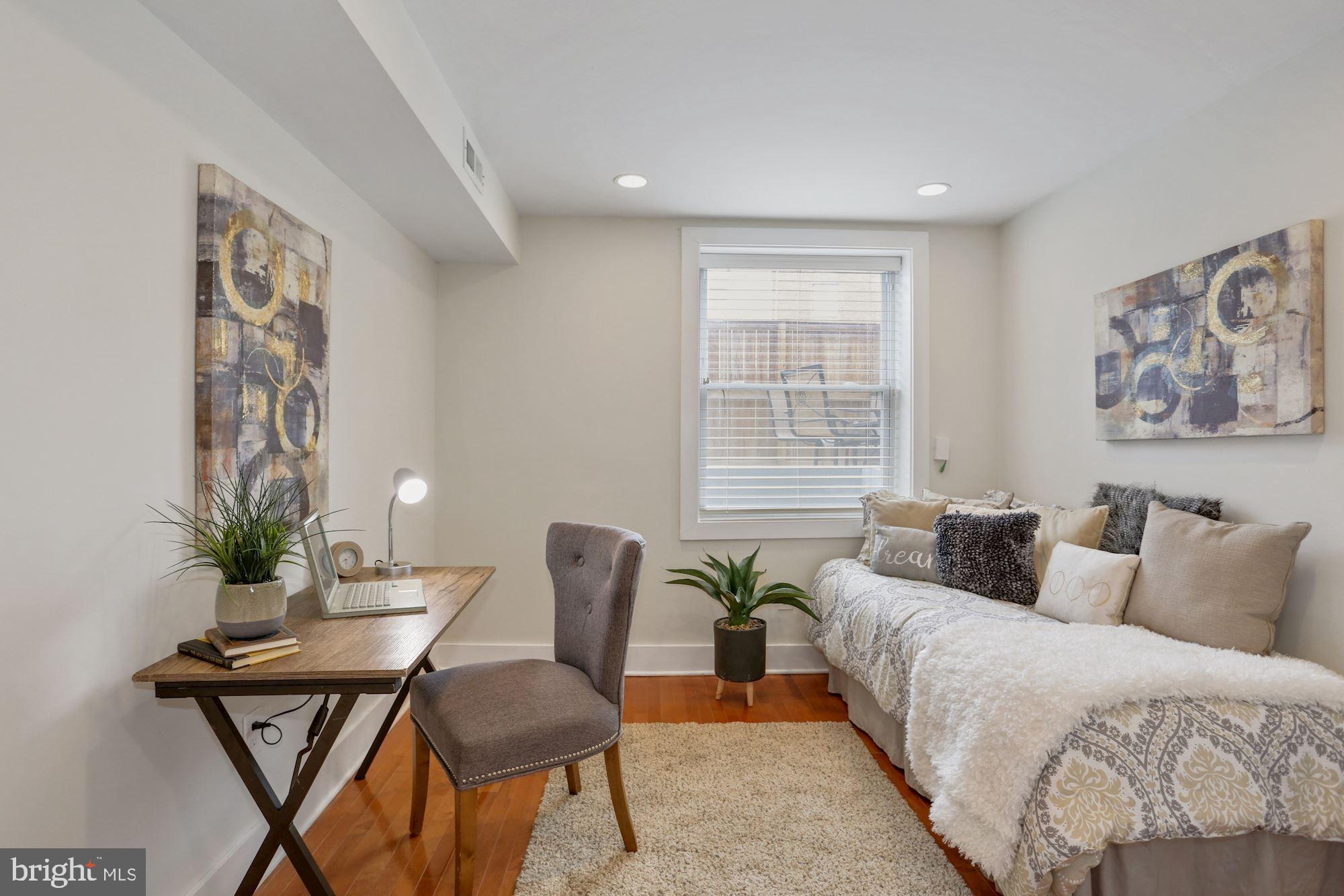 43 Hanover Place Northwest, Unit 1 Washington, DC 20001 - Photo 10 of 23 a living room with furniture and wooden floor
