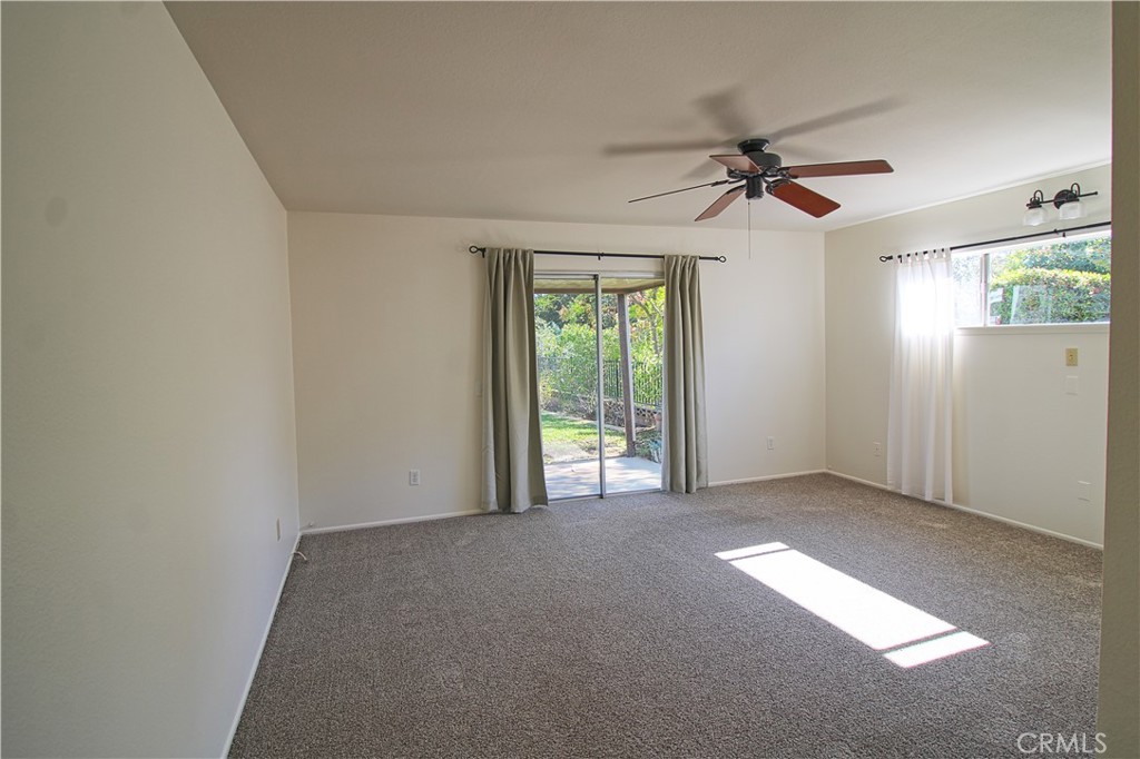 1235 Ruby Lane Calimesa, CA 92320 - Photo 11 of 17 an empty room with windows and fan