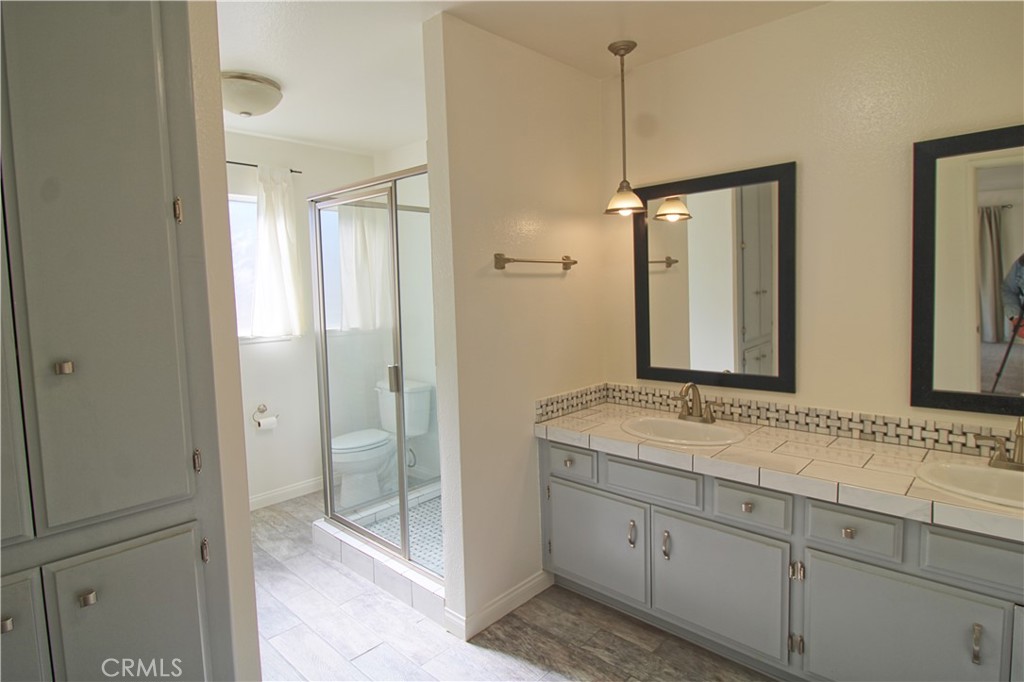 1235 Ruby Lane Calimesa, CA 92320 - Photo 12 of 17 a spacious bathroom with a shower sink and mirror