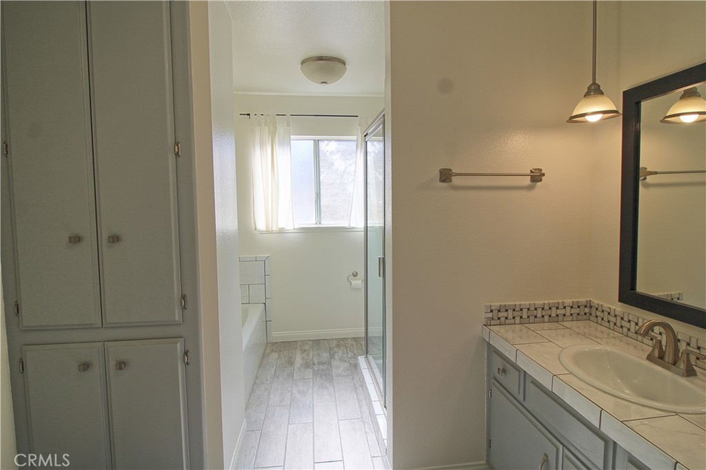 1235 Ruby Lane Calimesa, CA 92320 - Photo 13 of 17 a bathroom with a sink and shower