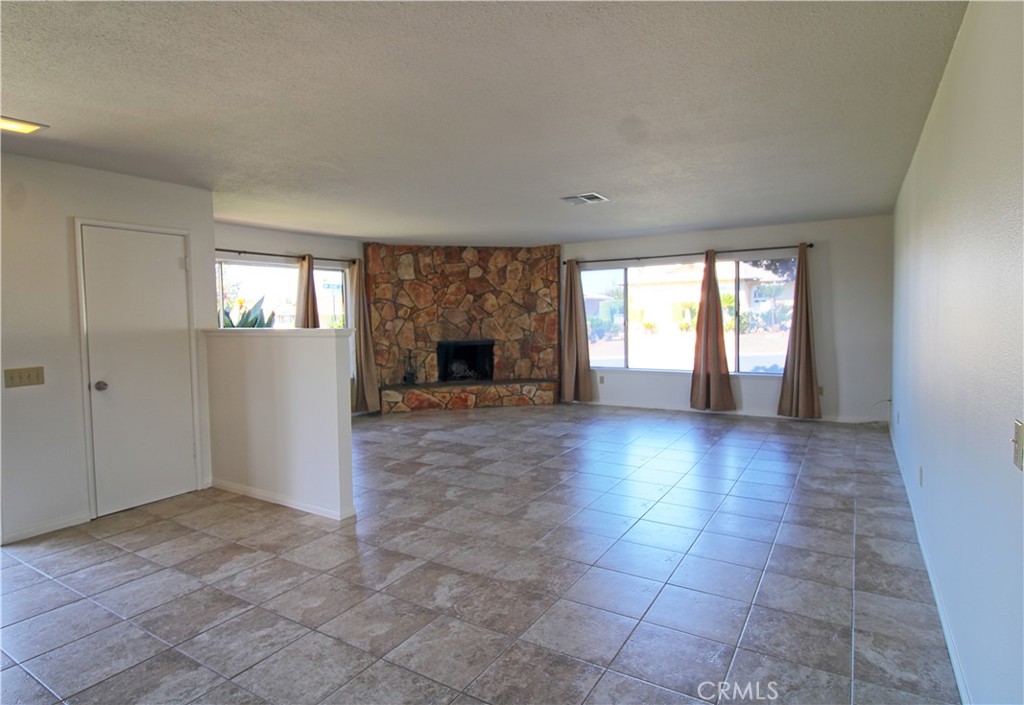 1235 Ruby Lane Calimesa, CA 92320 - Photo 3 of 17 an empty room with windows and fireplace