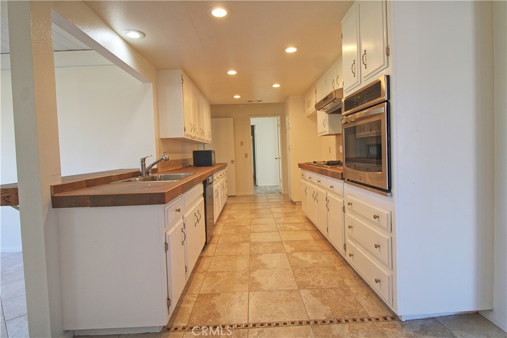 1235 Ruby Lane Calimesa, CA 92320 - Photo 6 of 17 a kitchen with stainless steel appliances a sink and cabinets