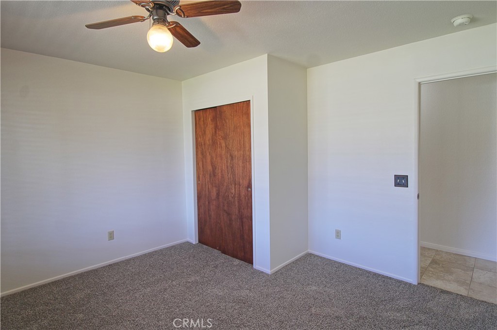 1235 Ruby Lane Calimesa, CA 92320 - Photo 9 of 17 an empty room with a fan & a window
