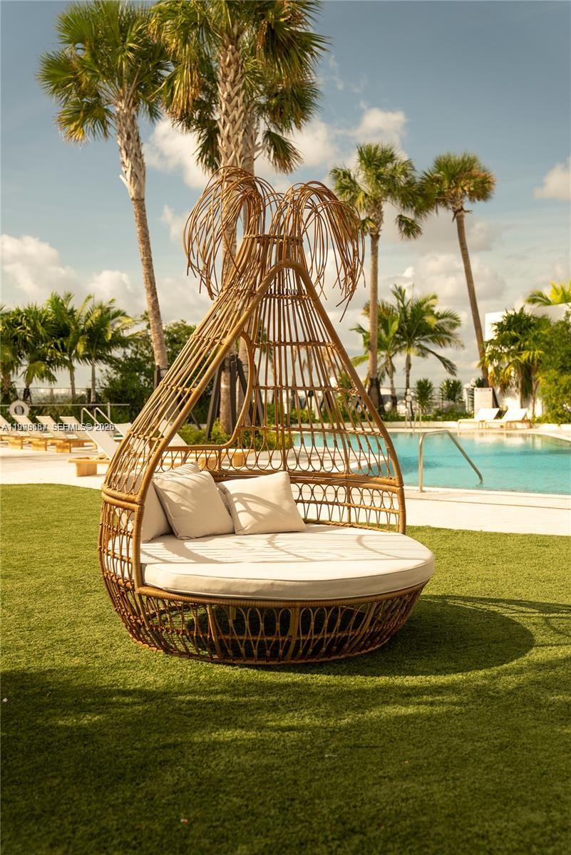 275 Southwest 6th Street, Unit 1110 Miami, FL 33130 - Photo 16 of 22 a view of swimming pool with a table and chair