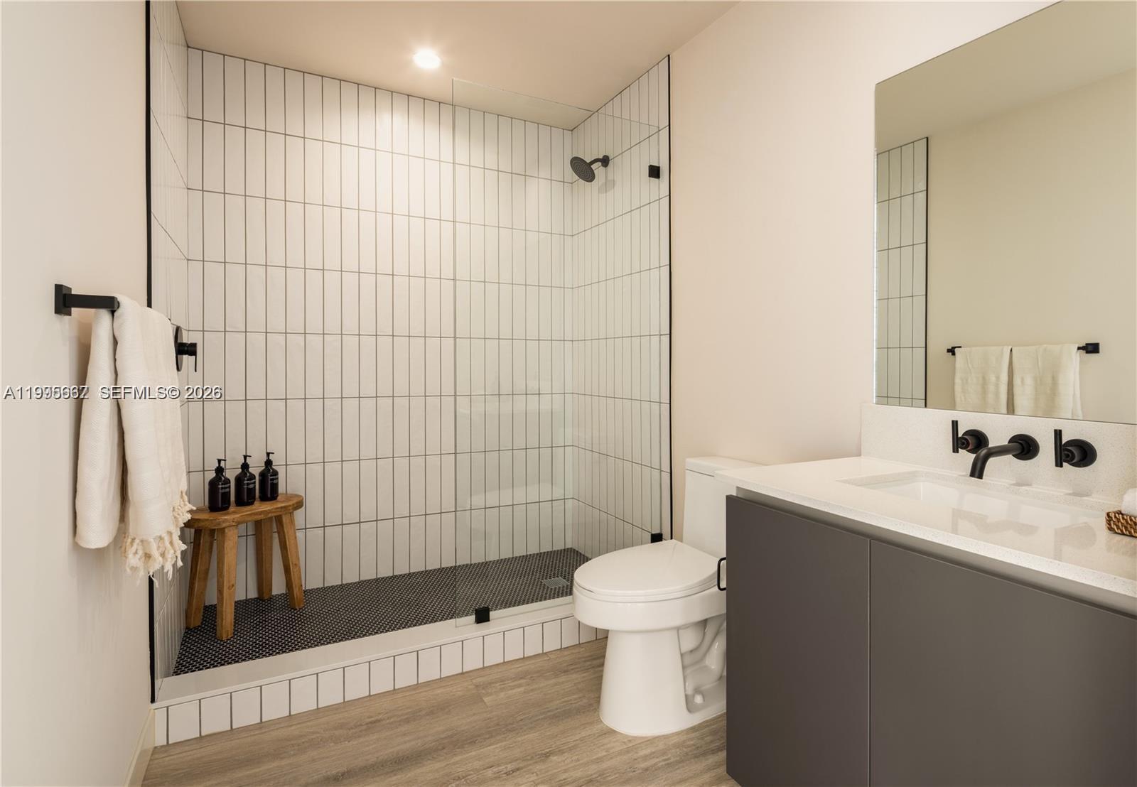 275 Southwest 6th Street, Unit 1110 Miami, FL 33130 - Photo 7 of 22 a bathroom with a sink a toilet and shower