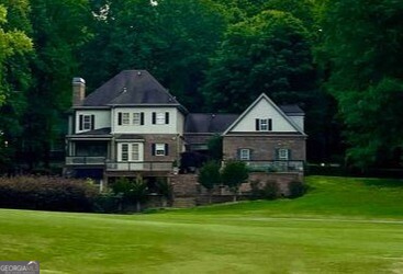 3 Club Drive Newnan, GA 30263 - Photo 1 of 43 a front view of a house with a yard and garage